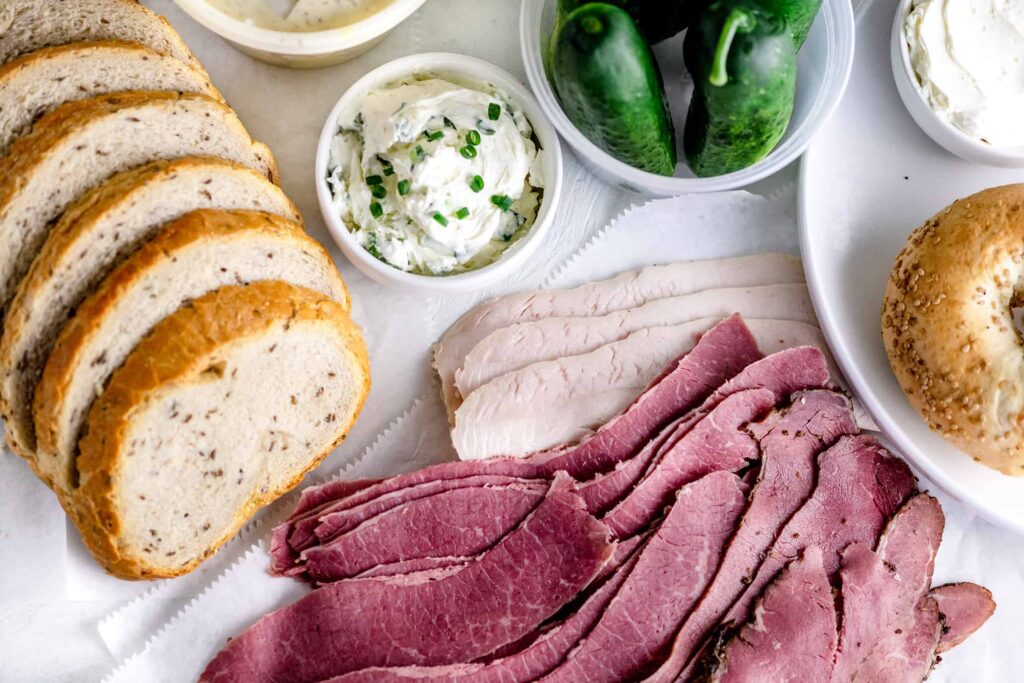 Slices of Bulk Corned Beef, Rye Bread, Turkey, New York Bagels, Cream cheese and Pickles