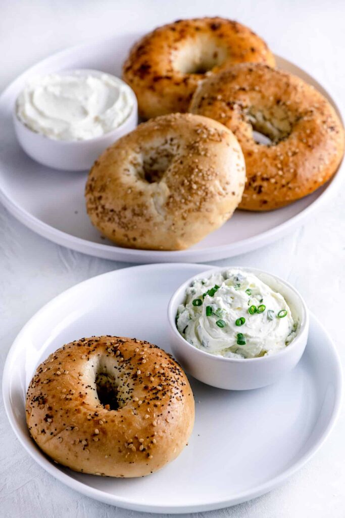 white plate of new york bagels and chive cream cheese in bowl