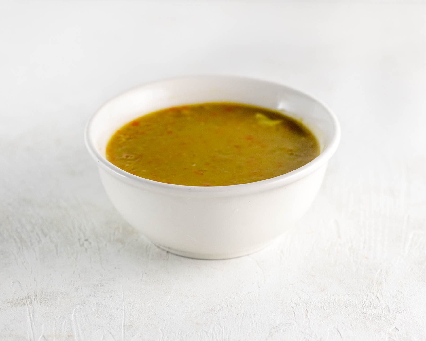split pea soup in a white cup