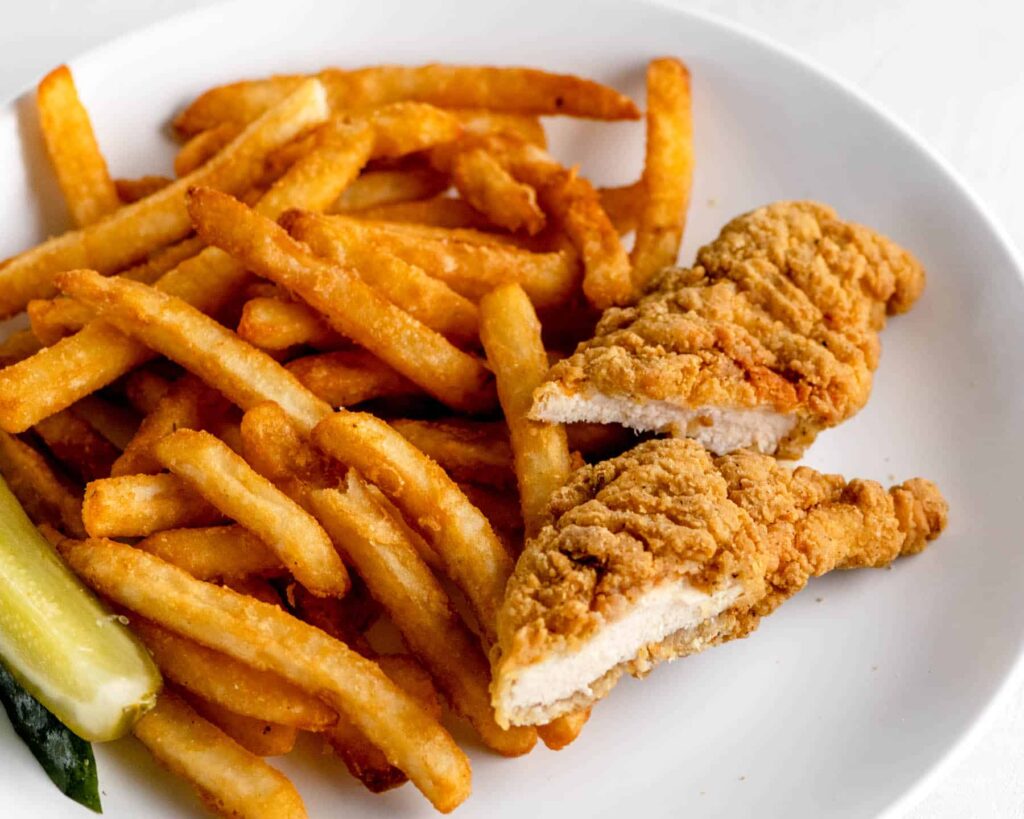 kids chicken tenders and fries on a white plate