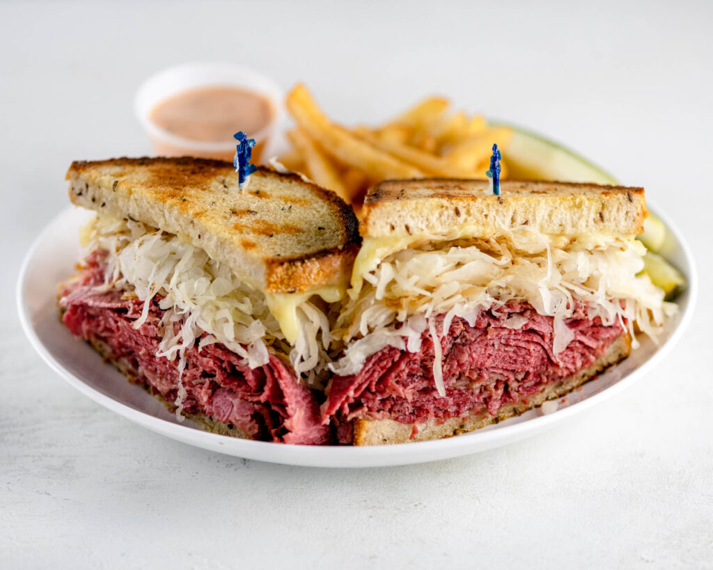 Reuben sandwich on white plate